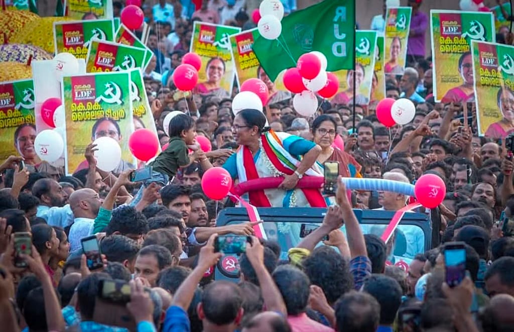 KK Shailaja greets supporters during her 2021 victory rally in Mattannur. Her handling of the Nipah outbreak and the COVID-19 pandemic had made her one of the most recognisable faces of the LDF government, helping her secure a record victory margin in the constituency.
