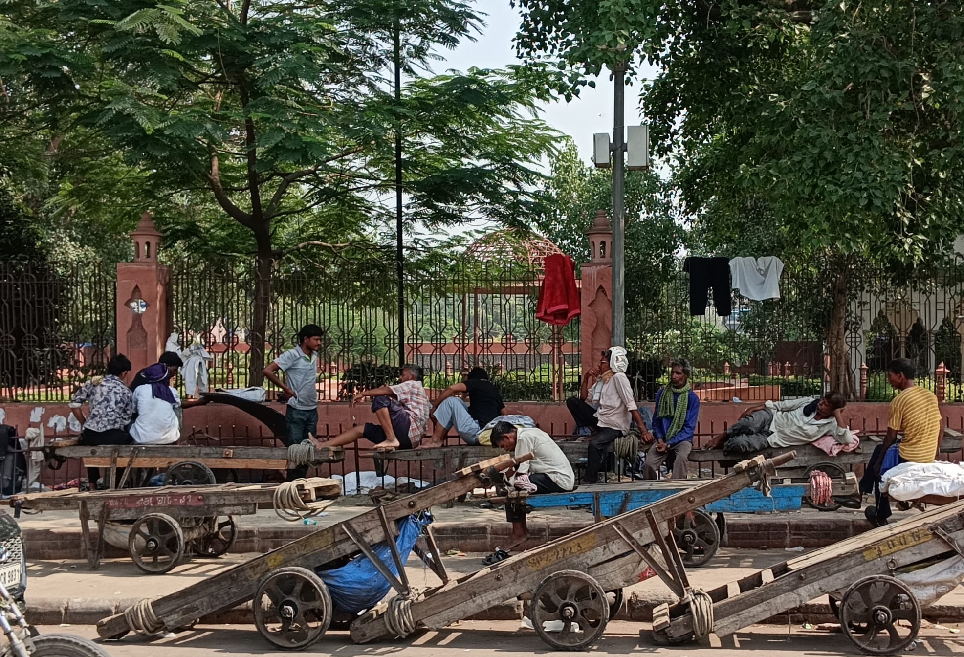 Hand-cart pullers waiting for their next gig in the unforgiving heat. 