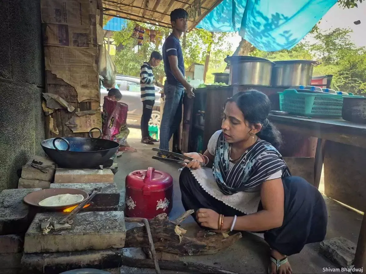 Sanghmitra Patra prepares chapatis over a traditional stove in her dhaba. The smoke and the heat forced her to narrow her menu down to dal, roti and rice. And her business has halved as customers avoid the smoke.