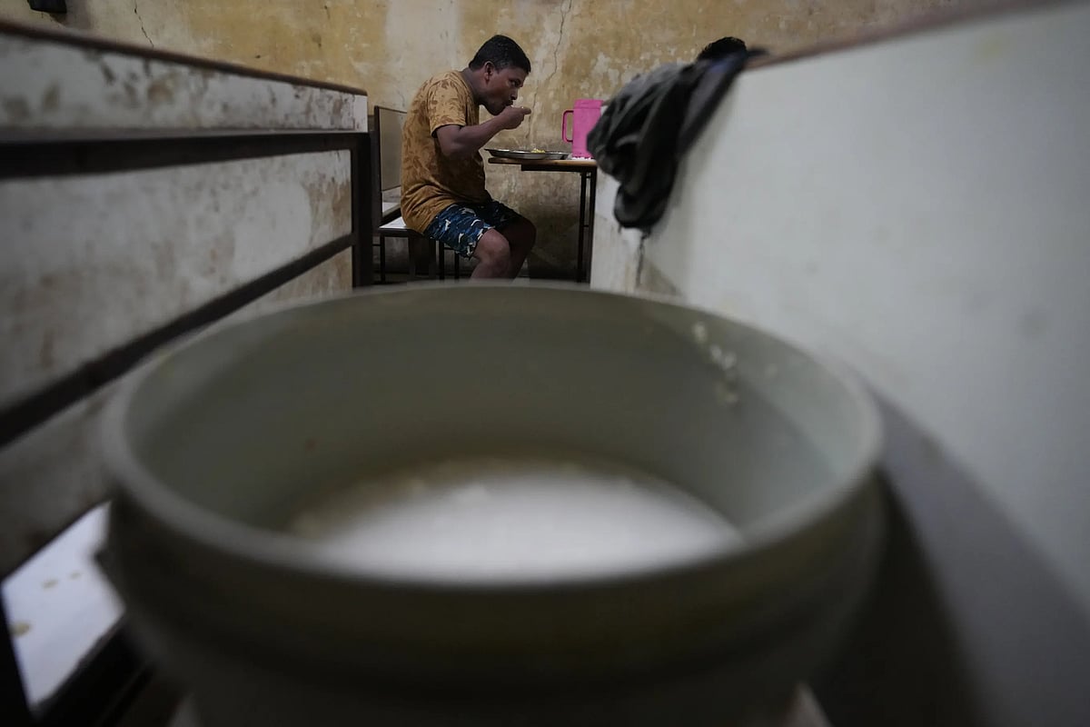 Sibaram Pradhan eats dinner at a hotel at his residential quarters. (AP Photo/Ajit Solanki)