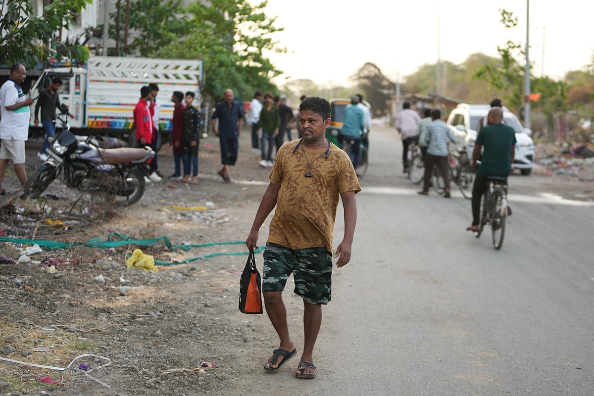 Sibaram Pradhan walks to work from his residential quarters. (AP Photo/Ajit Solanki)