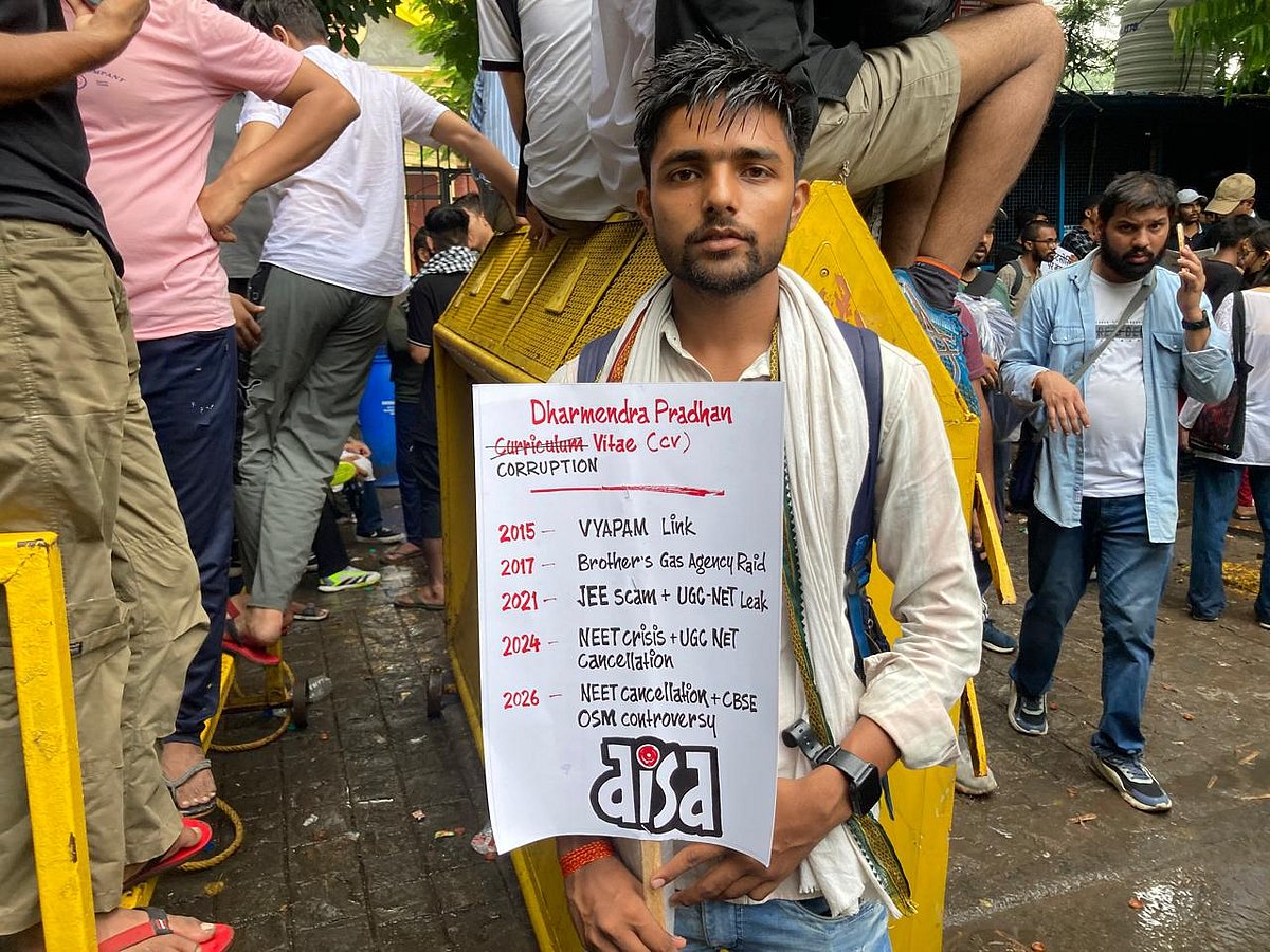 Dinesh holds a placard of AISA