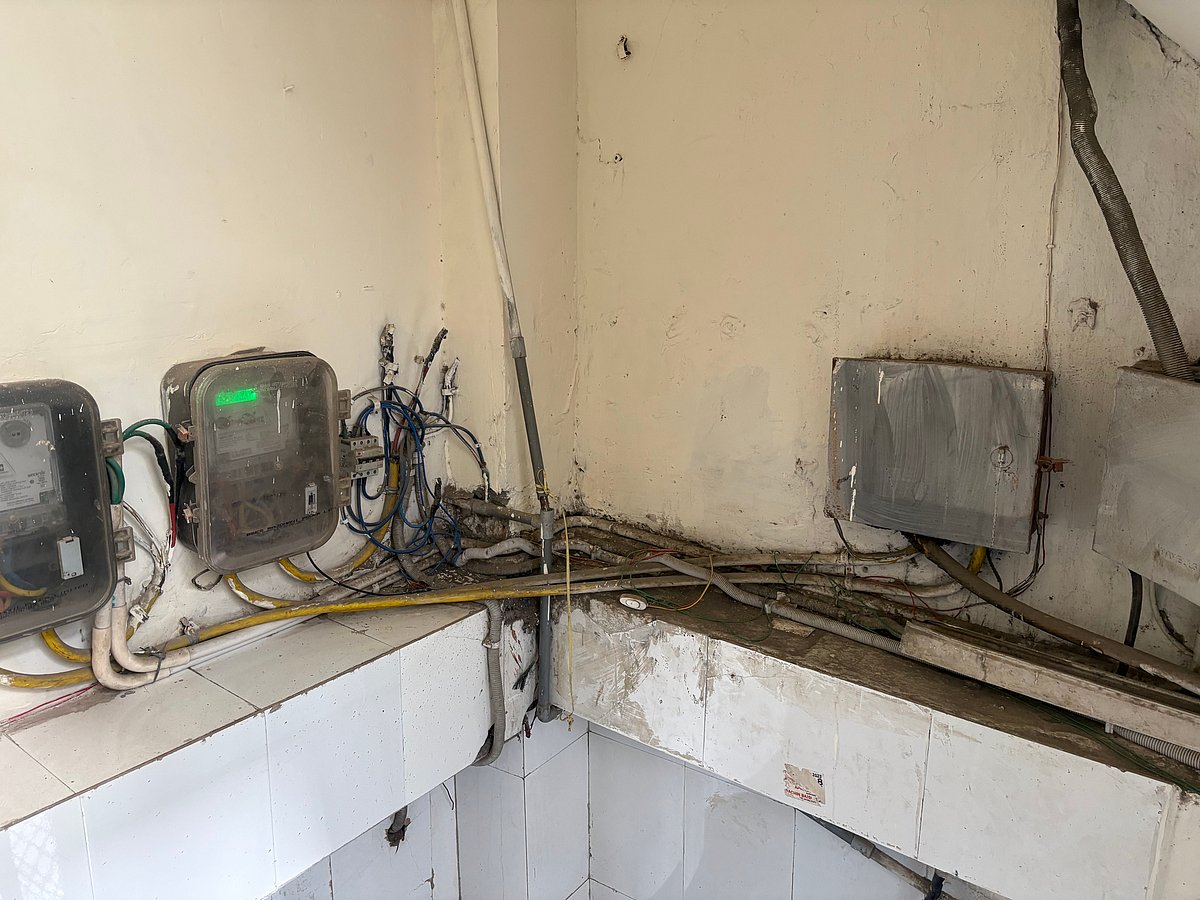 Electric wires dangling in the stairwell of Hostel Daze Girls' PG