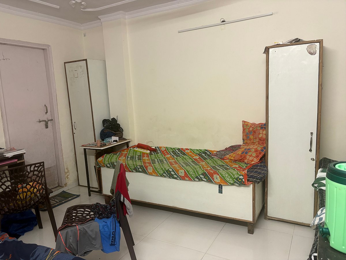 A triple-sharing room at a Satya Niketan PG