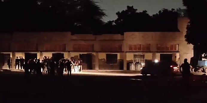 Detainees gathered outside the community centre (Screenshot)