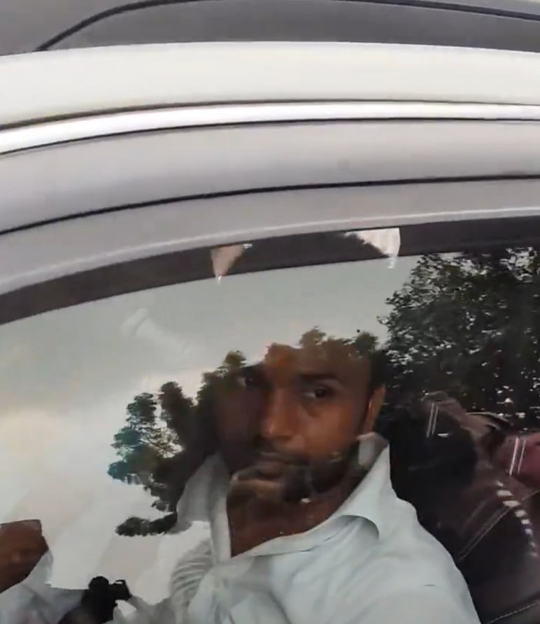 The front-seat passenger in the white shirt, one of the four men who fled in Pandey’s car after reporters asked police to check it for lathis.