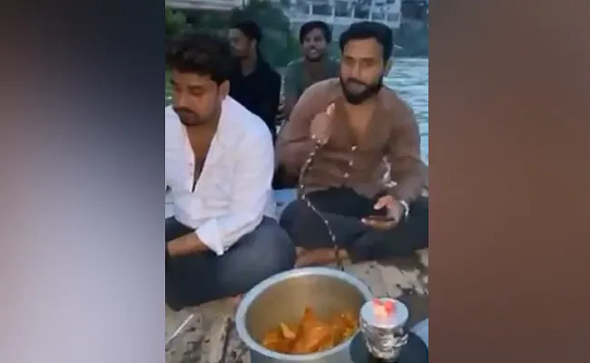 A video went viral of a group of men smoking hookah and cooking meat on a boat on the holy river Ganga