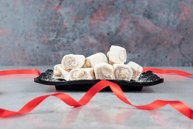 red ribbon laid around black platter marshmallows marble surface114579 75081