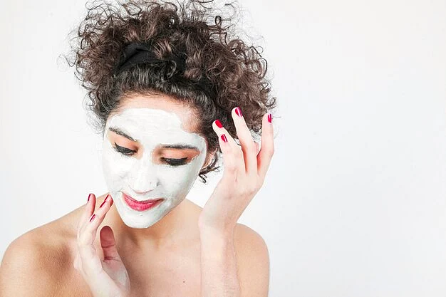 young woman applying cosmetic cream her face against white background23 2147901153