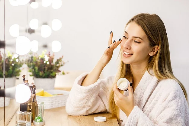 young beautiful blonde girl cares face skin with moisturizer front mirror 496169 939