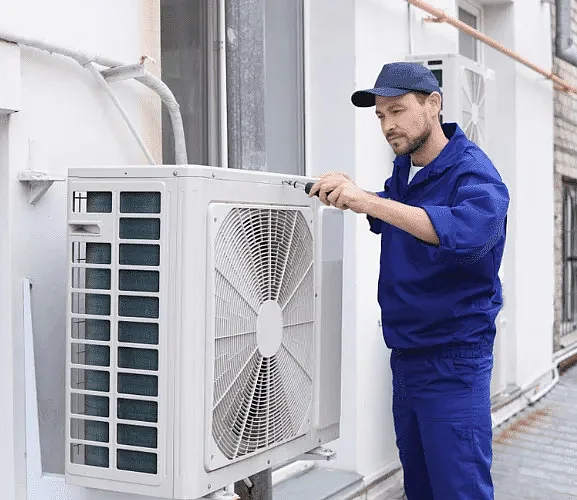 AC service technician doing repair jpg