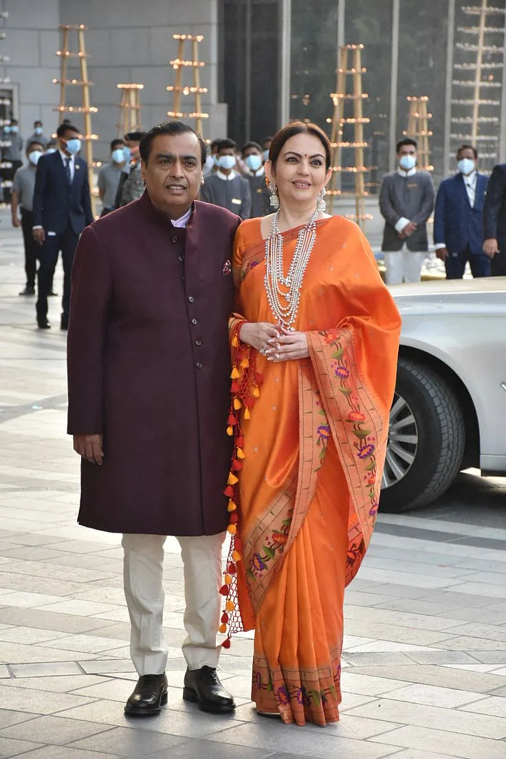 With Mukesh Ambani Nita Ambani Is Every Bit A Traditional Beauty In A Glorious Orange Saree