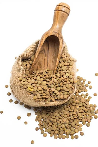 Fenugreek with oil in bottle over white background