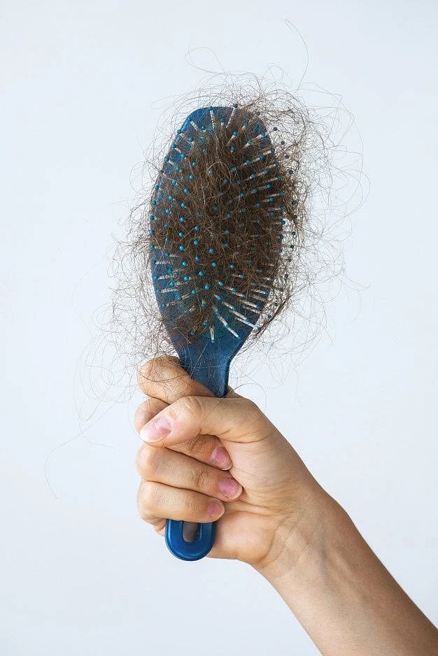 Premium Photo Hairbrush with a lot of female hair