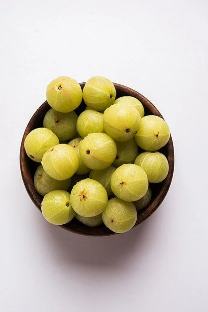 Premium Photo Indian gooseberry or Amla Phyllanthus emblica in a cane basket over colourful or wooden surface selective focus 1