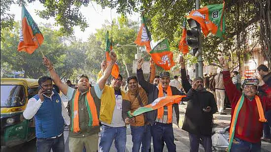 BJP supporters celebrate after early trends showed1738992038266