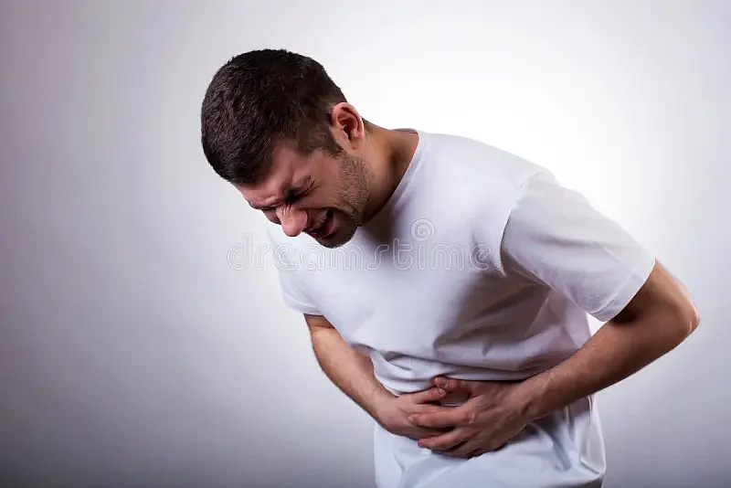 man stomachache young severe holding his stomach 38211064