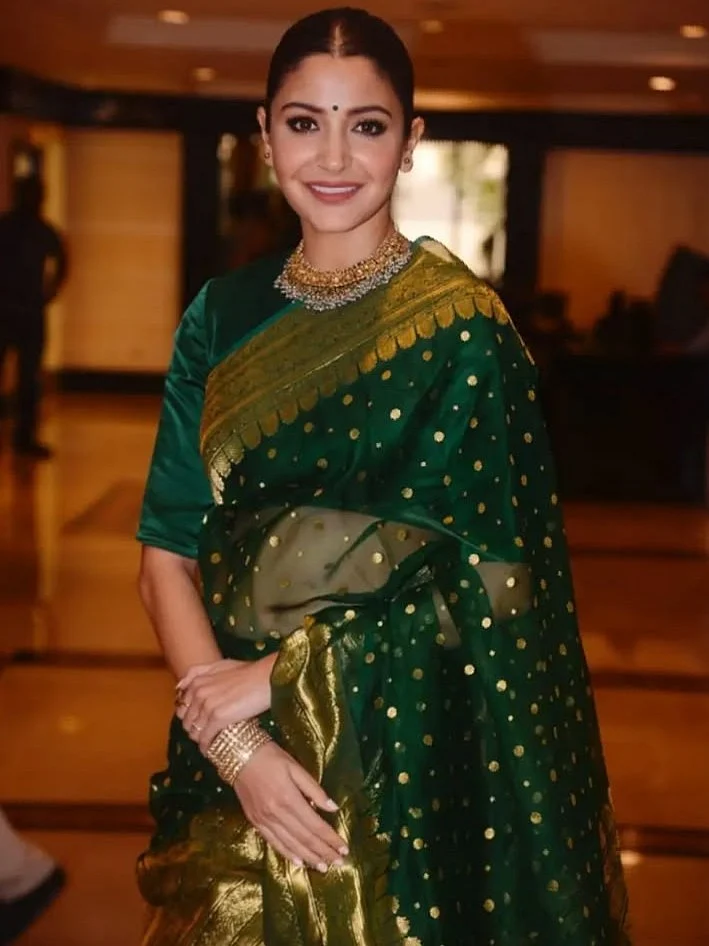 Bottle Green Chanderi Saree with gold kaath border Complementing the saree is a contemporary gold k