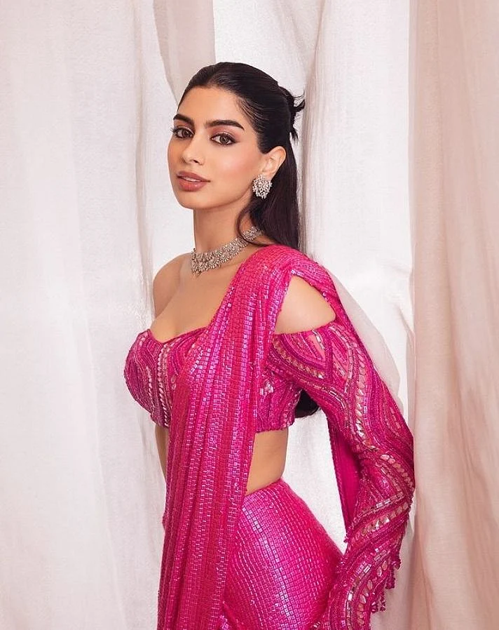 khushi kapoor in a custom manish malhotra rani pink sequined sari with an off shoulder blouse
