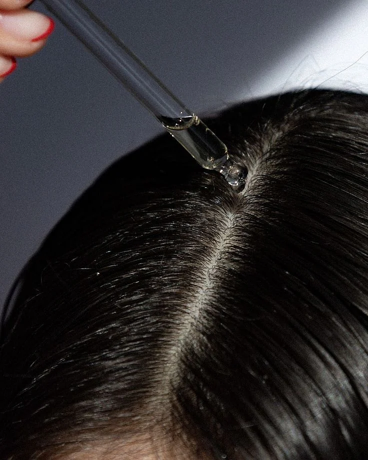 applying oil to the hair 5