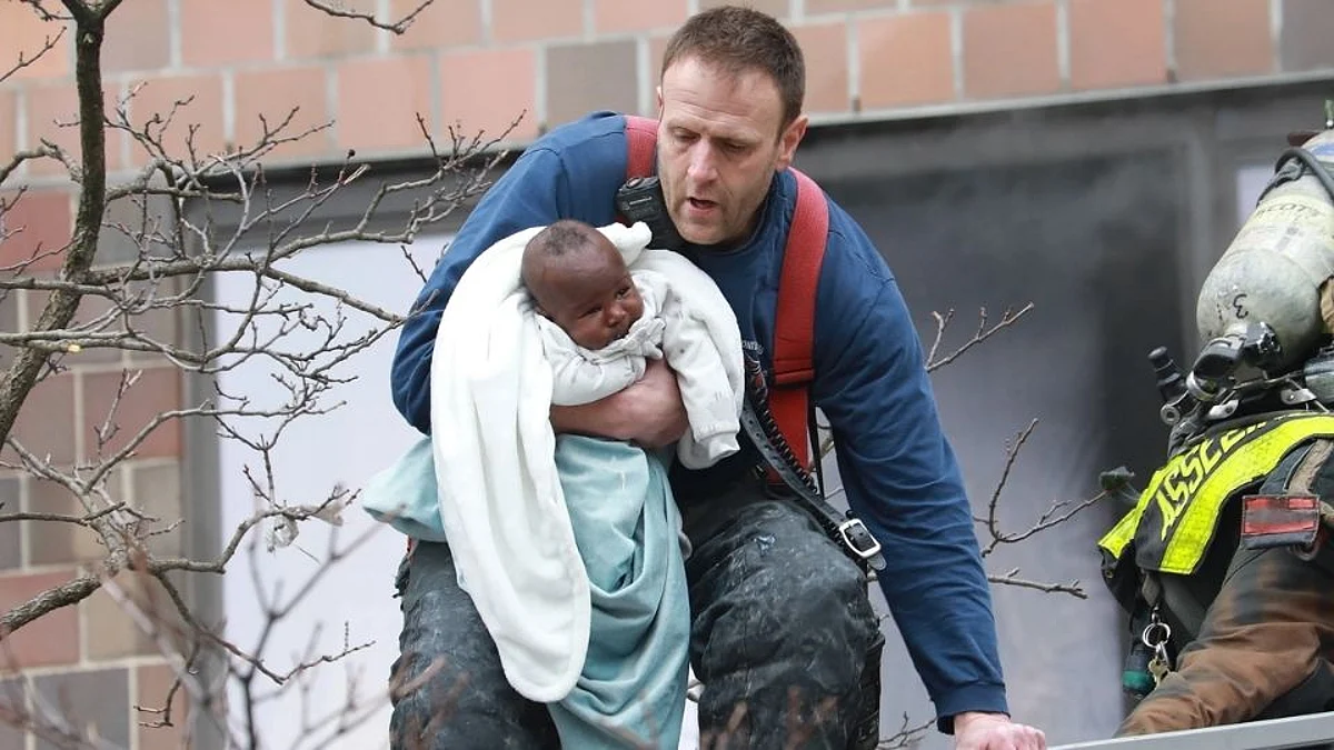 Fire fighter Matt Zimpfer rescuing a baby from deadly bronx fire
