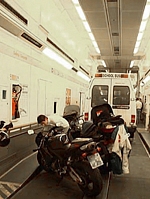 Bikes and minibus inside a Eurotunnel shuttle wagon. (Wikimedia Commons/Bleiglass)