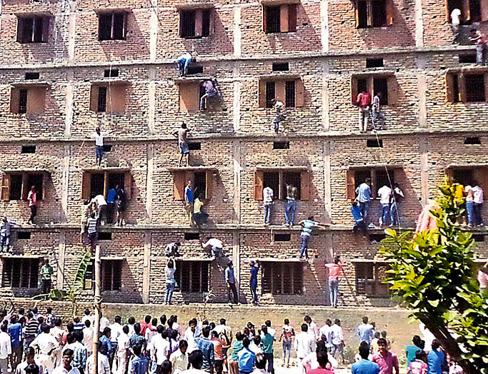 Parents in Bihar were caught scaling walls of buildings that housed exam halls,
as expertly as Spider-Man, to help their children with their answers.