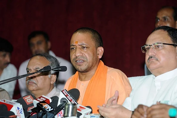 Uttar Pradesh Chief Minister Yogi Adityanath along with Central Minister J P Nadda addresses a press conference at BRD Medical Centre in Gorakhpur. (Deepak Gupta/Hindustan Times via Getty Images)
