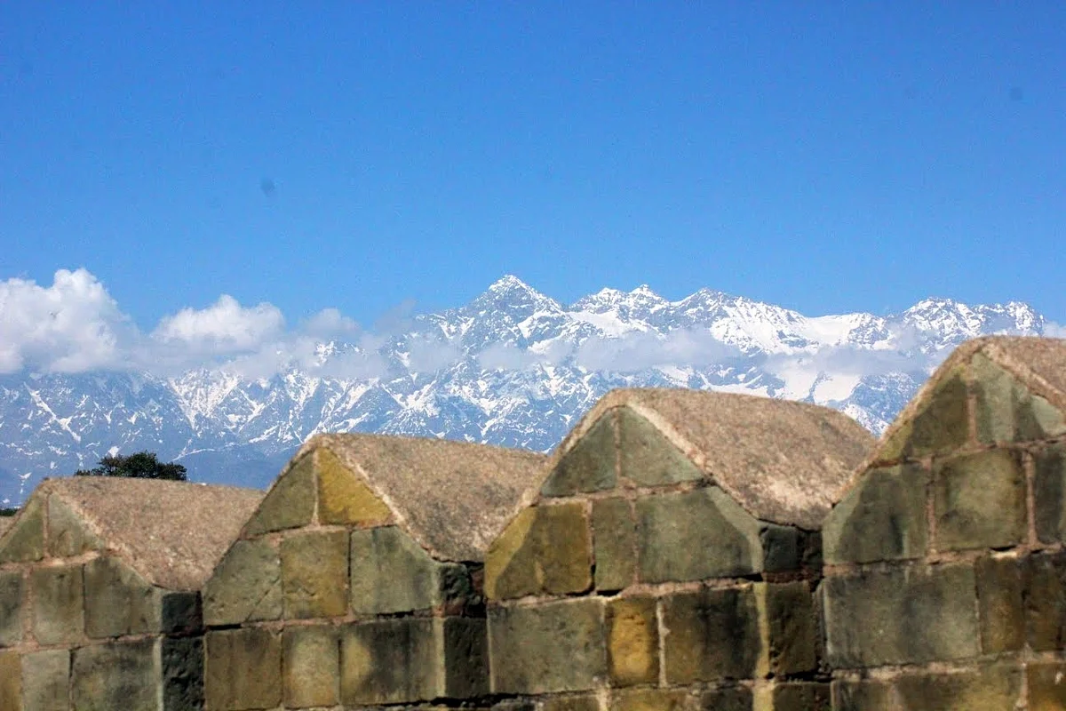 A view of the snow-clad Dhauladhars from the ramparts of the historic Kangra fort in Himachal. (YouTube)
