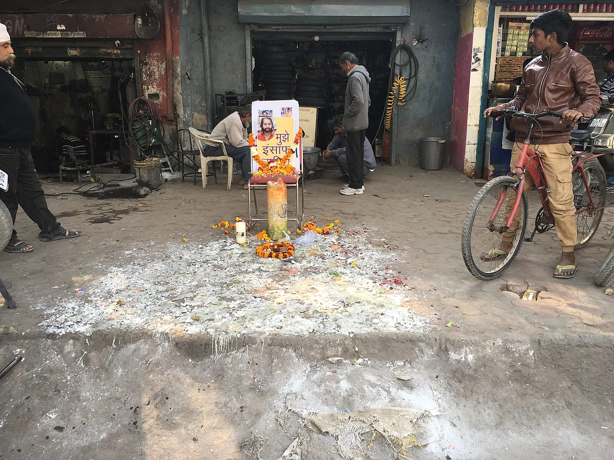 A candlelight vigil at the market junction where Ankit Saxena was killed.