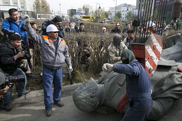 The Lenin Statue in Ulan Bator lies dismantled as people surround it and take pictures. (Paula Bronstein via Getty Images)