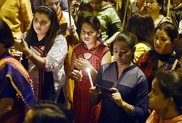 Delhi BJP youth wing observes a candle-light march protesting rape of the minor.