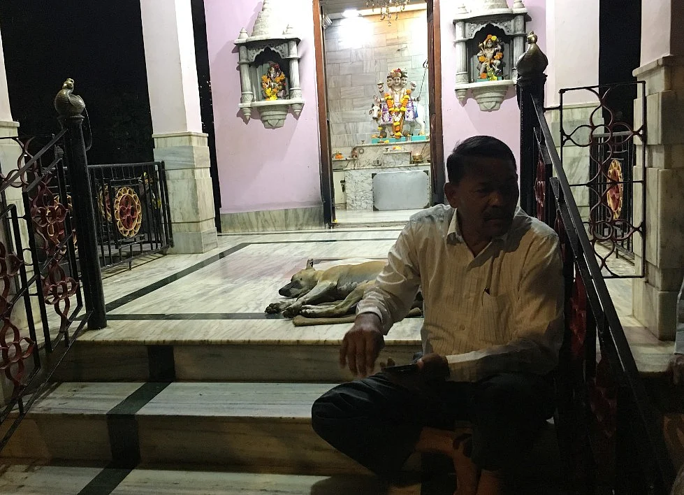 Padelkar sits at the temple steps as he awaits his team to gather.