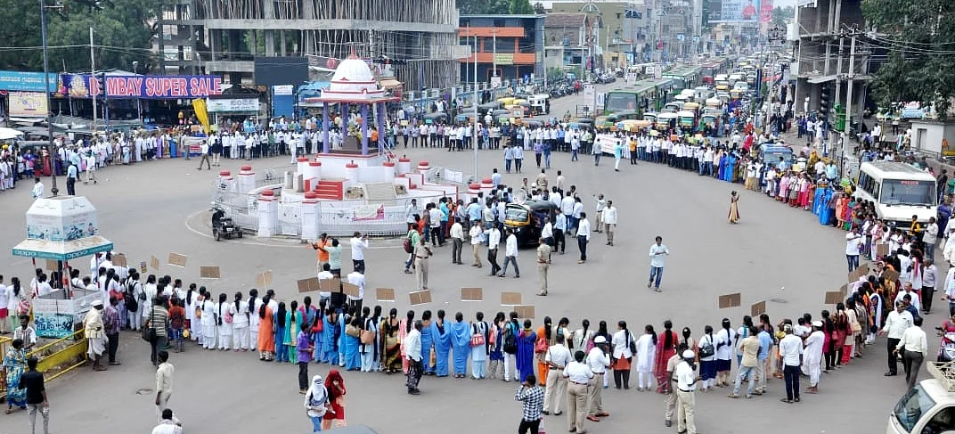 Health department contract workers stage a demonstration at a traffic junction in Vijayapura. 
