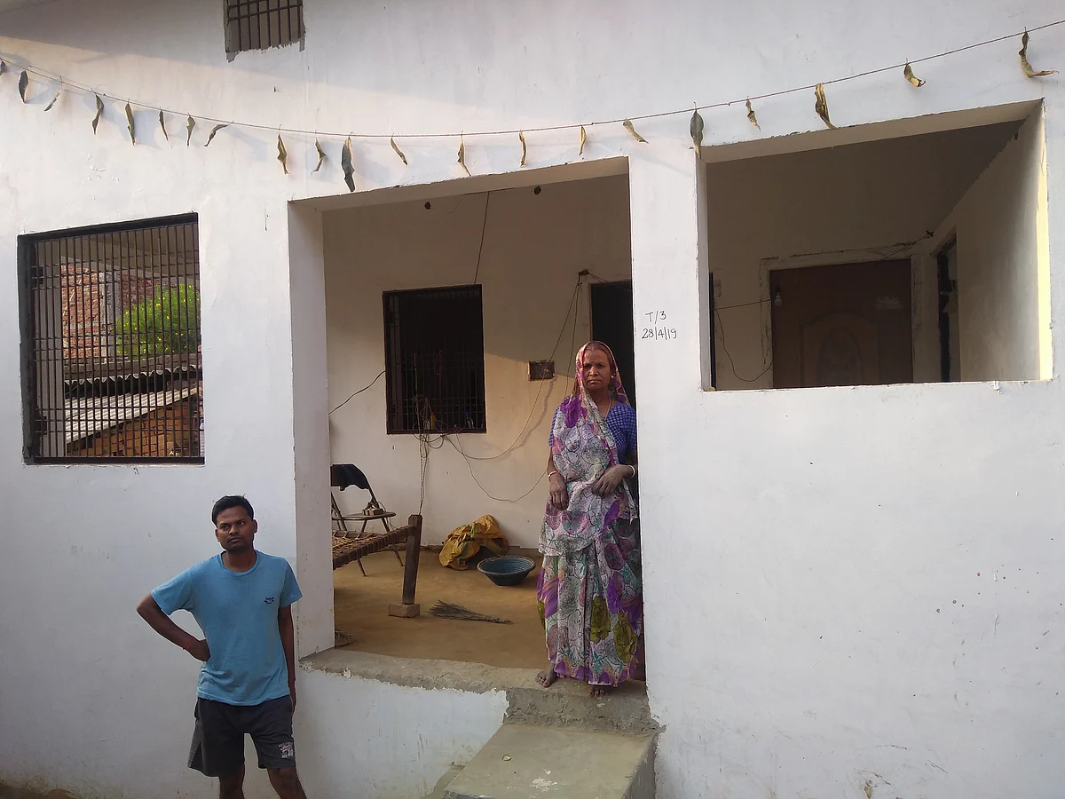 Malti Nishad standing in front of her home for which she also used a part of her savings. (Prakhar Gupta/Swarajya)