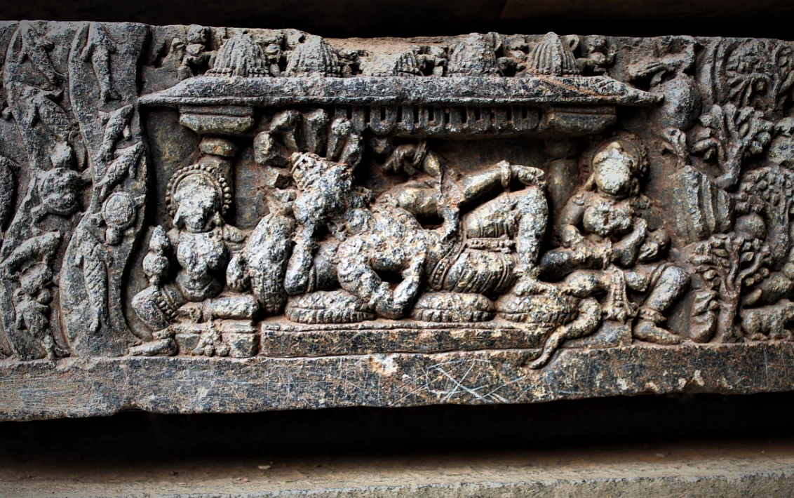 Maha Vishnu on the celestial milk ocean reclining on Adishesha with Lakshmi pressing his feet.