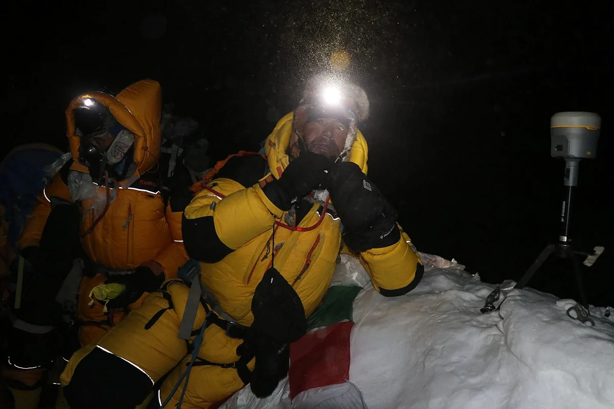 Nepali surveyor Khim Lal Gautam (right) at the summit of Mount Everest in the early hours of 22 May. On his left is a satellite navigation device to measure the mountain’s peak. 