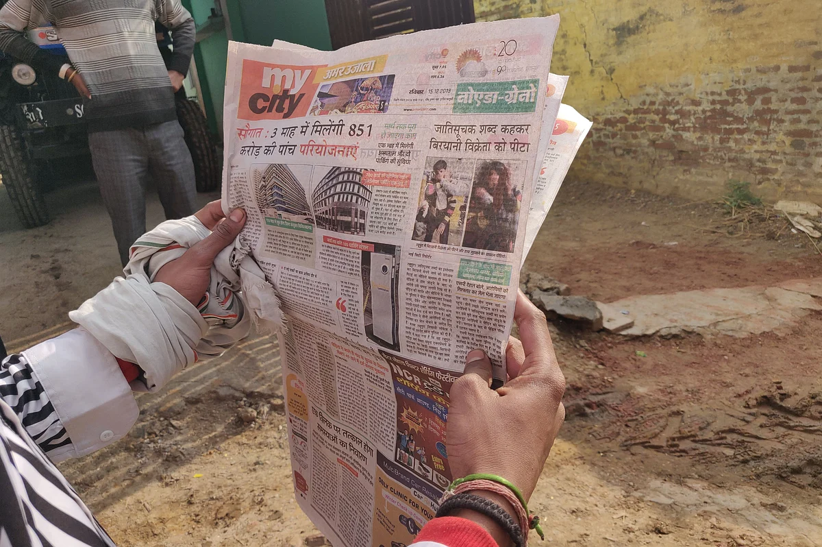 A resident of Mohammadabad reads the news of the incident 