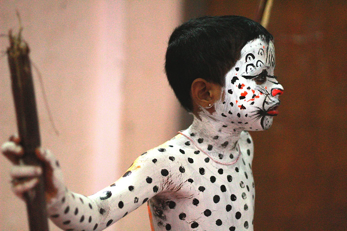 A tiger cub holding two staves and standing as the painters paint them all night. Picture: Team Kalicharan.