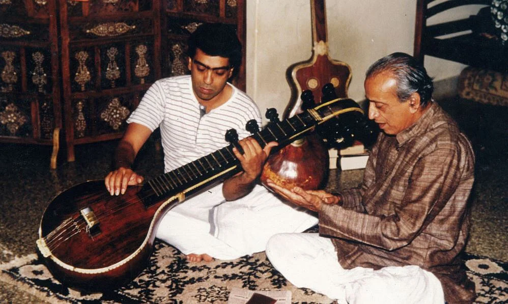 Young Balakrishna learning from his father Veene Doreswamy Iyengar