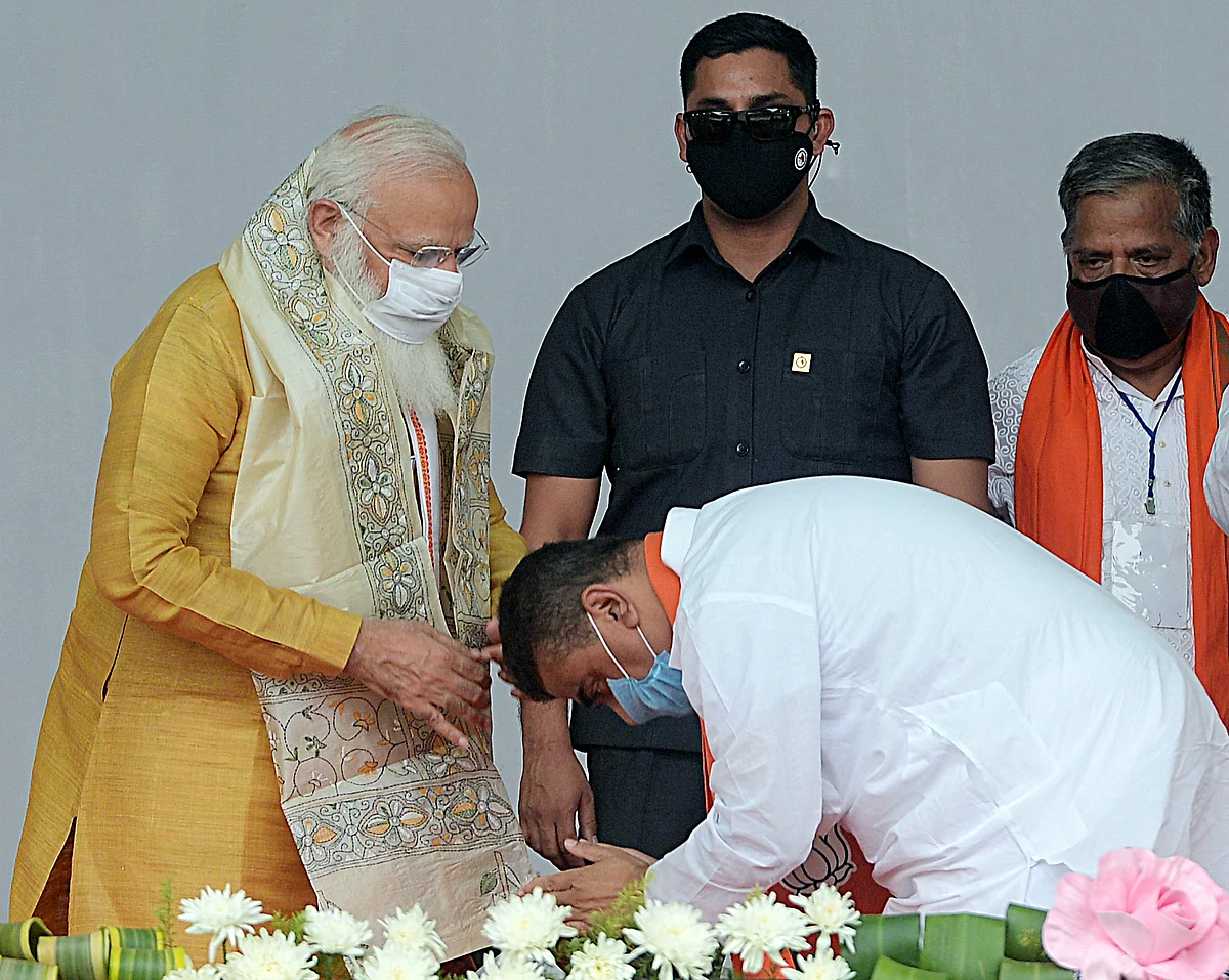 BJP leader Suvendu Adhikari seeks blessings of Prime Minister Narendra Modi during a public rally ahead of assembly elections at Contai in East Midnapore on Wednesday.