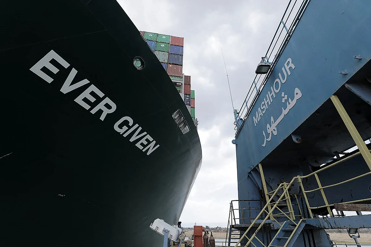 A handout picture released by the Suez Canal Authority on March 26, 2021, shows the Taiwan-owned MV Ever Given (Evergreen), a 400-metre- (1,300-foot-)long and 59-metre wide vessel, lodged sideways and impeding all traffic across the waterway of Egypt's Suez Canal.