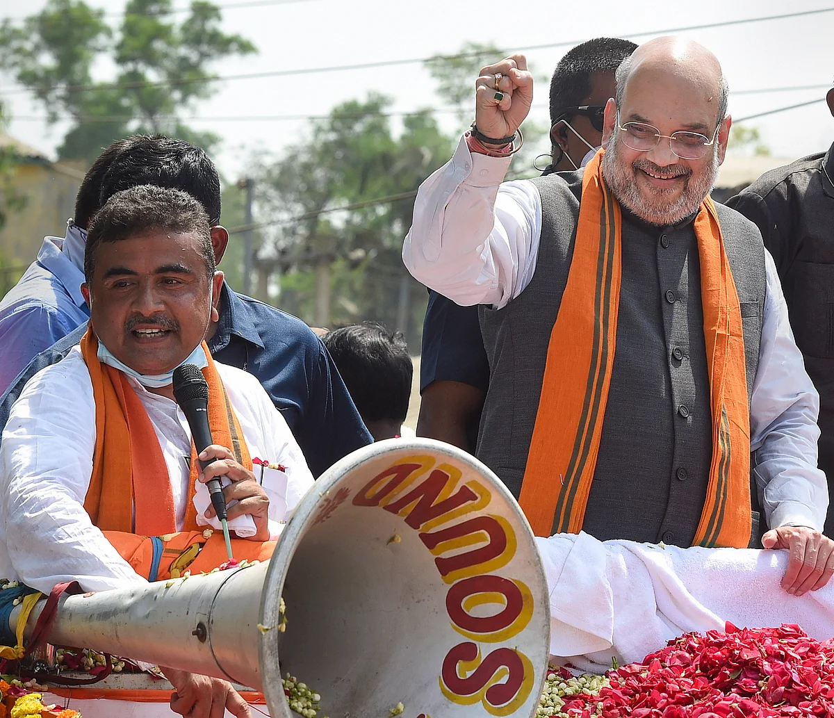 Union Home Minister Amit Shah during a road show in support of BJP candidate Suvendu Adhikari (L) from Nandigram Constituency for the Assembly elections, in Nandigram, Tuesday, March 30, 2021