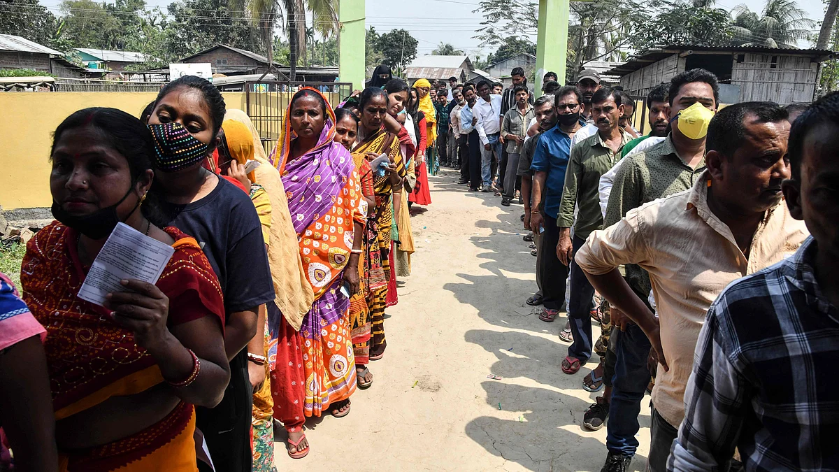 Voters wait in queue to cast their ballots during Phase 1 of Assam's legislative election in Koliabor, some 186 km from Guwahati on March 27, 2021.