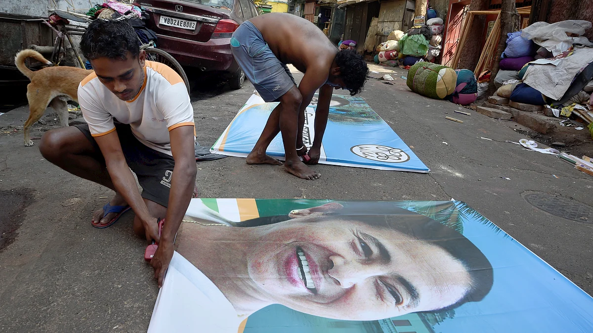 Workers busy in making banners of Trinamool Congress chief Mamata Banerjee ahead of Assembly polls, in Kolkata, Saturday, March 6, 2021.