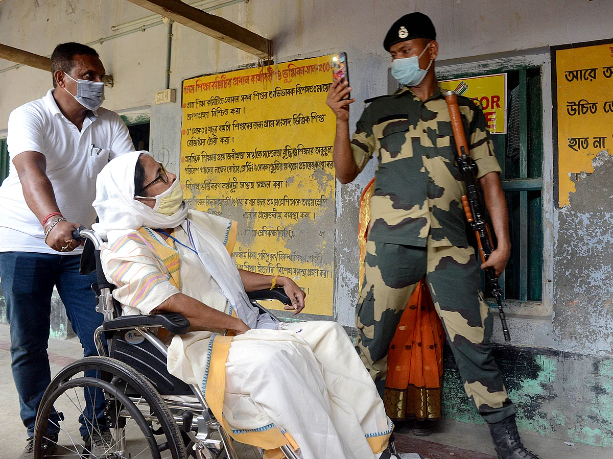 Paramilitary personnel clicks a picture as West Bengal Chief Minister Mamata Banerjee visits a polling booth at Boyal in Nandigram on April 1.