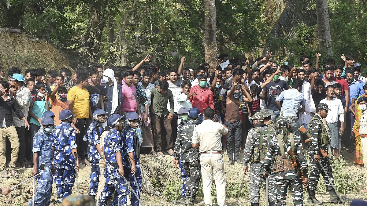 Nandigram: Security personnel keep vigil as villagers raise slogans against West Bengal Chief Minister Mamata Banerjee, waiting inside a polling station, during the second phase of West Bengal assembly polls, at Boyal in Nandigram, Thursday, April 1, 2021.