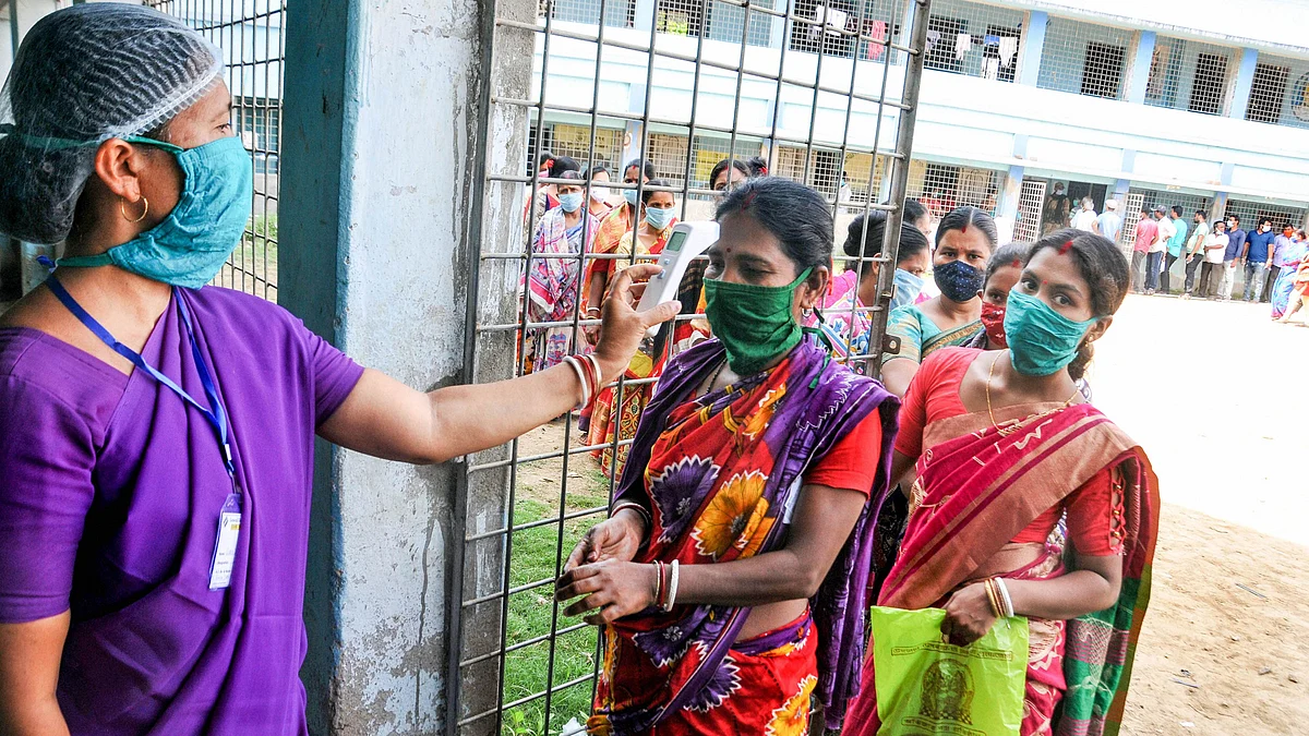 South 24 Parganas: Voters undergo thermal screening as they arrive to cast their votes at a polling station during the second phase of West Bengal Assembly Polls, at Kakdwip in South 24 Parganas district, Thursday, April 1, 2021.