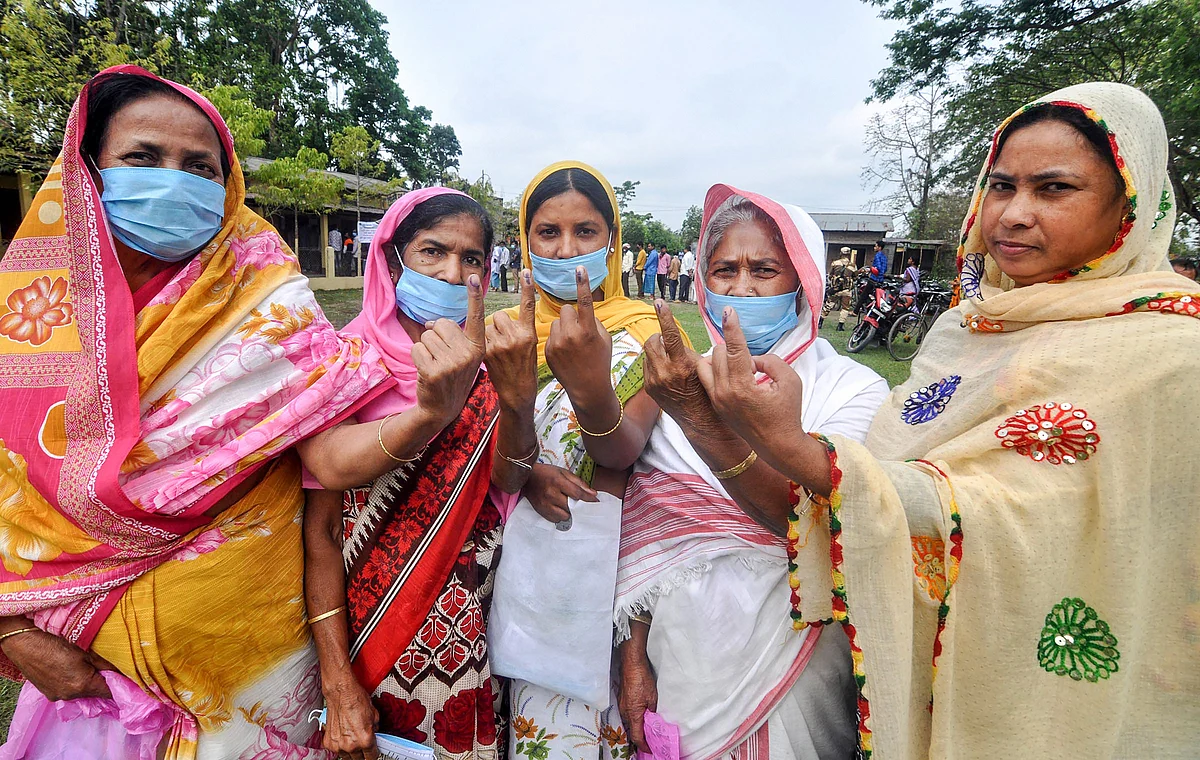 Darrang: Voters show thier fingers marked with indelible ink after casting their votes for the second phase of Assam Assembly polls, at Sipajhar in Darrang district, Thursday, April 1, 2021.