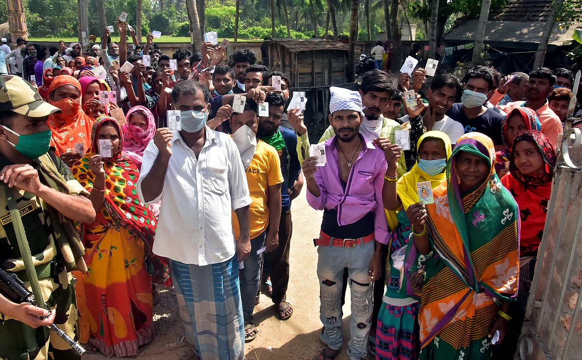 Voters show their voter-ID cards as they arrive to cast their vote in Nandigram during the second phase of the West Bengal Assembly election on April 1.